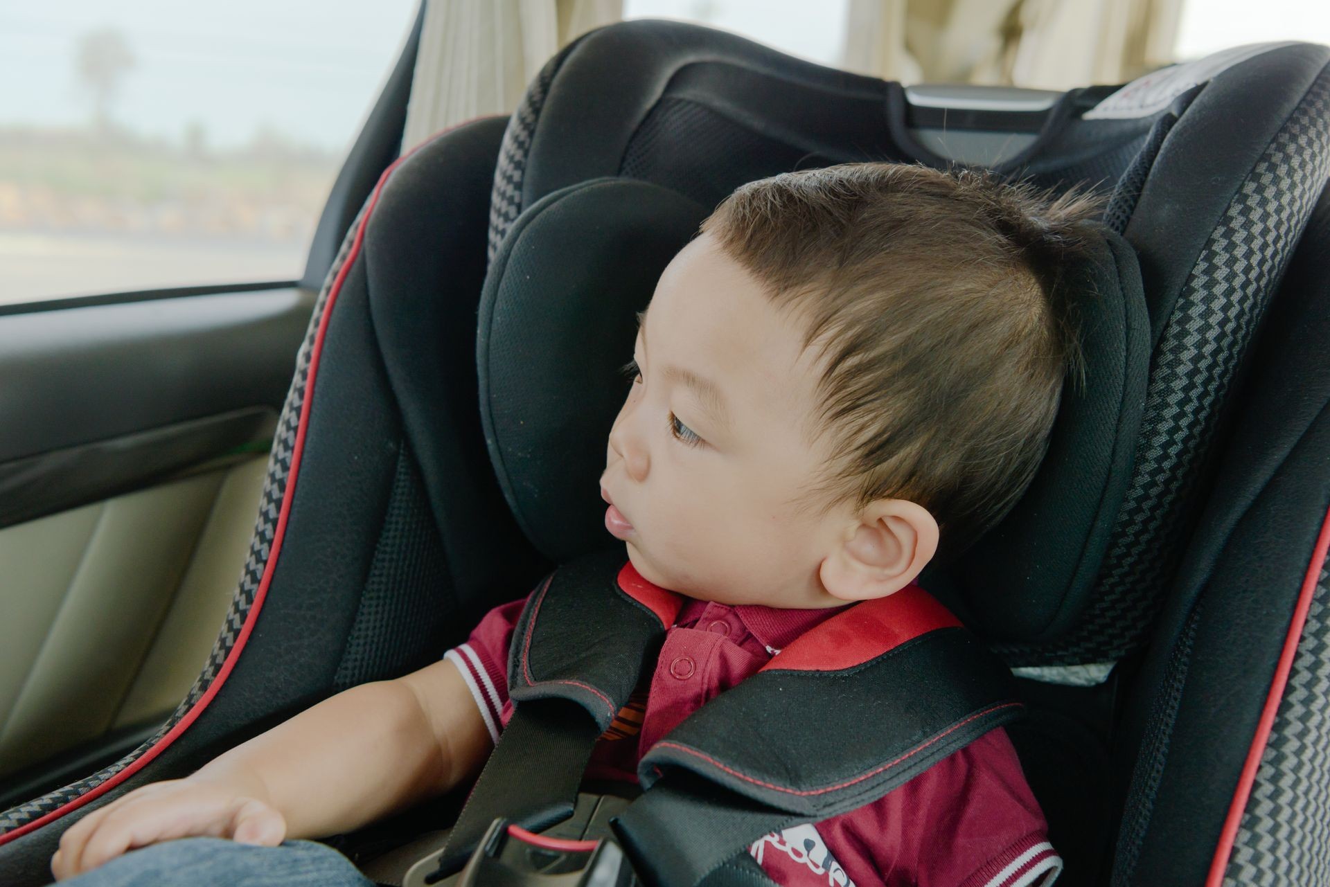 Adorable baby boy in safety car seat